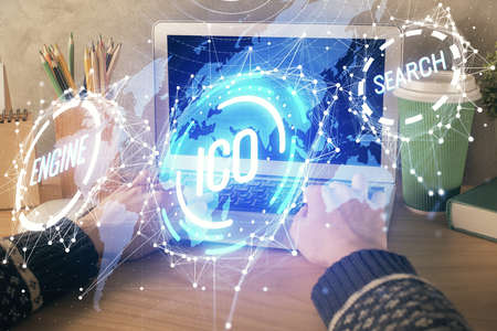 Double exposure of woman hands typing on computer and crypto market theme hologram drawing....