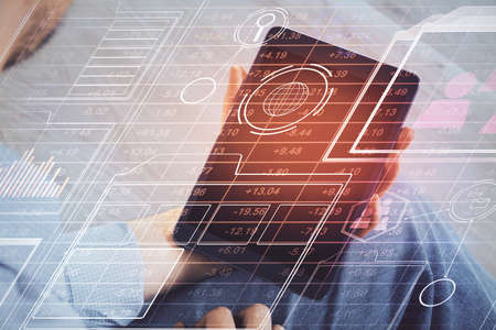 Double exposure of man's hand holding and using a digital device and data theme drawing. Technology...