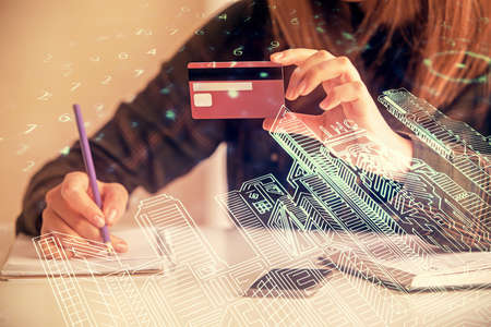 Multi exposure of woman on-line shopping holding a credit card and construction drawing. e-commerce concept.の写真素材