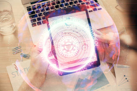 Double exposure of man's hands holding and using a digital device and tech theme hologram drawing. Technology concept.の写真素材