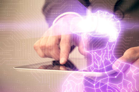 Double exposure of man's hands holding and using a digital device and AR glasses drawing. Virtual...