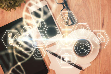 Double exposure of DNA drawing over table with phone. Top view. Science education concept.の写真素材