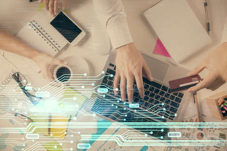 Double exposure of man's hands typing over computer keyboard and data theme hologram drawing. Top...