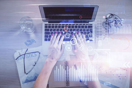 Double exposure of woman hands working on computer and data theme hologram drawing. Top View....