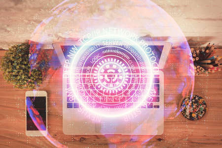 Technology hologram drawing over computer on the desktop background. Top view. Double exposure. Tech...