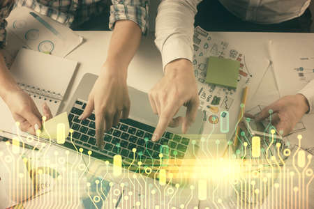 Double exposure of man and woman working together and data theme hologram drawing. Computer...