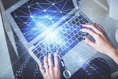 Double exposure of woman hands working on computer and data theme hologram drawing. Top View. Technology concept.の写真素材