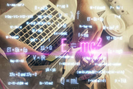 Double exposure of woman hands typing on computer and formula hologram drawing. Education concept.の写真素材
