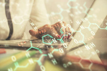 Double exposure of woman hands typing on computer and formula hologram drawing. Education concept.の写真素材