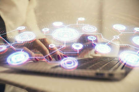 Double exposure of woman hands typing on computer and social network theme hologram drawing. People media concept.の写真素材