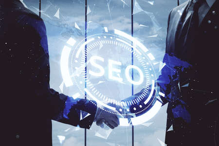 Double exposure of SEO hologram and handshake of two men. Search optimization concept.の写真素材