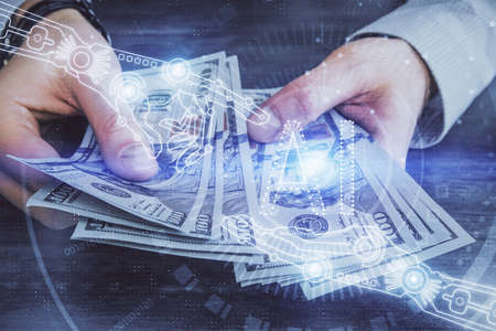 Multi exposure of technology drawing hologram and us dollars bills and man hands. Data conceptの写真素材
