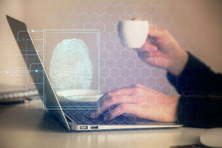 Double exposure of woman hands typing on computer and fingerprint drawing. Security concept.の写真素材
