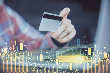 Double exposure of man hands holding a credit card and data theme drawing. E-commerce and technology concept.の写真素材