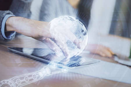 Double exposure of map drawing and man and woman working together holding and using a mobile device....