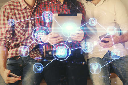 Double exposure of social network theme drawing and man and woman working together holding and using a mobile device.の写真素材