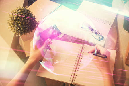 Multi exposure of woman on-line shopping holding a credit card and tech theme drawing. technology...
