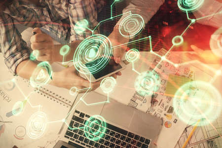 Double exposure of social network theme drawing and man and woman working together holding and using...