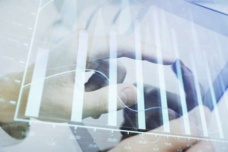 Multi exposure of man's hands holding and using a phone and financial chart drawing. Market analysis...