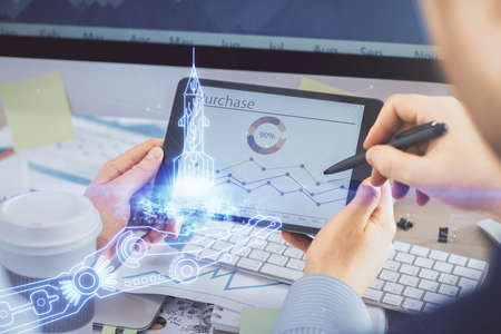Double exposure of man's hands holding and using a mobile device and creative hologram drawing.