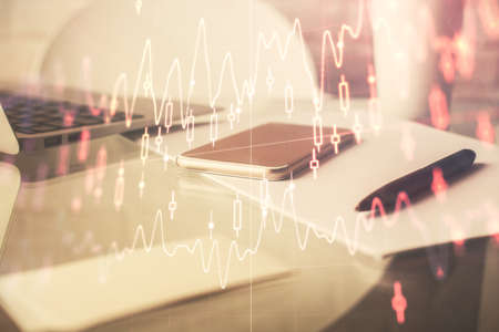 Double exposure of forex graph drawing and cell phone background. Concept of financial data analysisの写真素材