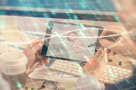 Double exposure of man's hands holding and using a phone and financial chart drawing. Market analysis concept.の写真素材