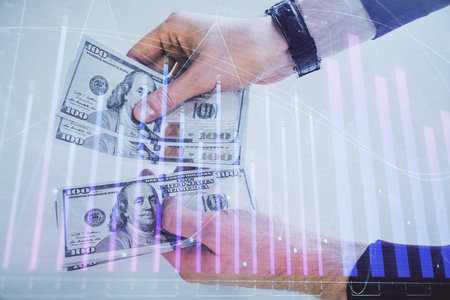 Multi exposure of financial graph drawing hologram and USA dollars bills and man hands. Analysis concept.の写真素材