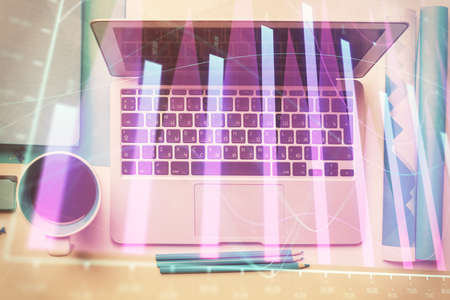 Double exposure of forex graph drawing over desktop background with computer. Concept of financial analysis. Top view.の写真素材
