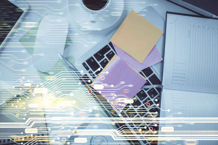 Double exposure of data hologram sketch over study table background with computer. Concept of Ai....