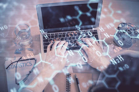 Double exposure of man's hands typing over computer keyboard and formula hologram drawing. Top view....