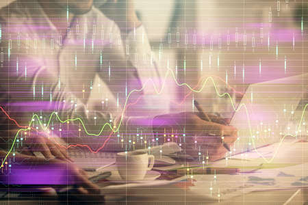 Multi exposure of man and woman working together and financial chart hologram. Business concept....