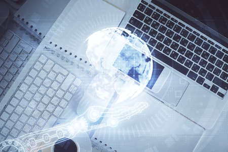 Double exposure of map hologram drawing over study table background with computer. Concept of...