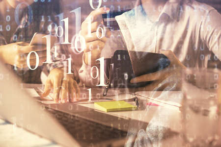 Double exposure of man and woman on-line shopping holding a credit card and data theme hologram...