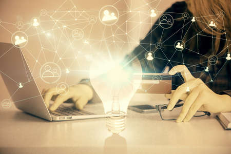 Multi exposure of woman on-line shopping holding a credit card and bulb drawing. Choice concept.