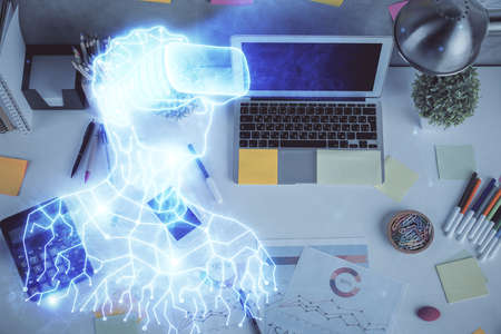 AR hologram drawings over computer on the desktop background. Top view. Multi exposure. Concept of...