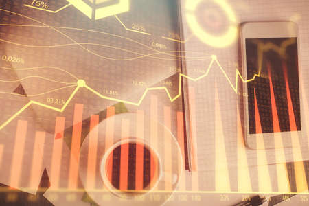 Multi exposure of forex graph hologram over desktop with phone. Top view. Mobile trade platform...