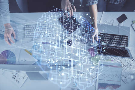 Double exposure of man and woman working together and brain drawing hologram. Intellectual...