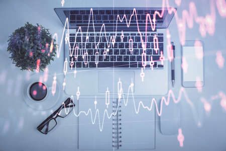 Multi exposure of forex chart drawing over table background with computer. Concept of financial research and analysis. Top view.の写真素材