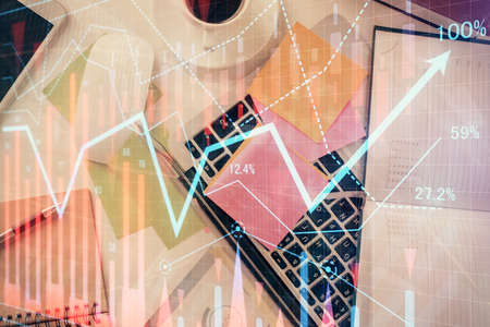 Multi exposure of financial chart drawing over table background with computer. Concept of research and analysis. Top view.の写真素材