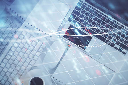 Financial market graph and top view computer on the desktop background. Multi exposure. Investment...