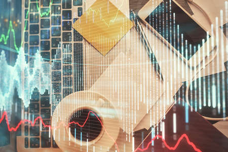 Double exposure of financial chart drawing over table background with computer. Concept of research...