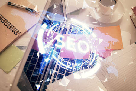 Double exposure of SEO drawing over study table background with computer. Concept of search. Top view.の写真素材