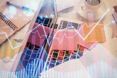 Multi exposure of financial chart drawing over table background with computer. Concept of research...