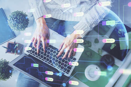 Double exposure of woman hands working on computer and data theme hologram drawing. Top View....