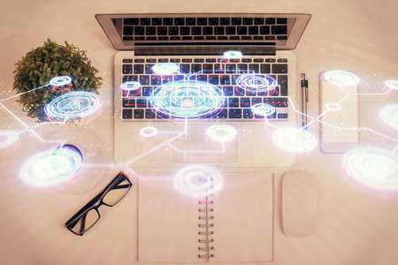 Social network hologram drawings over computer on the desktop background. Top view. Multi exposure. Concept of people connection.の写真素材