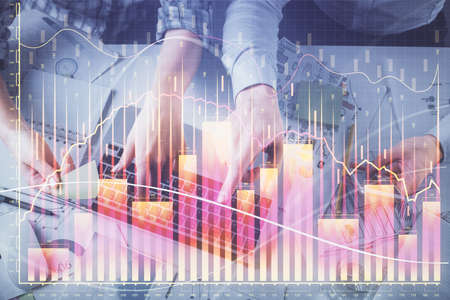 Double exposure of man and woman working together and forex graph hologram drawing. Financial analysis concept. Computer background. Top View.の写真素材