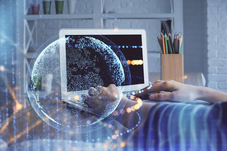 Double exposure of woman hands working on computer and world map hologram drawing. International...