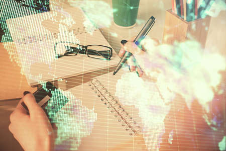 Multi exposure of woman on-line shopping holding a credit card and financial theme drawing. Business...