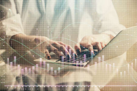 Double exposure of woman hands typing on computer and forex chart hologram drawing. Stock market...