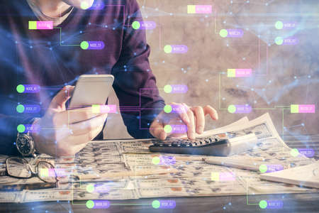 Multi exposure of man's hand holding and using a digital device and data theme drawing. Innovation concept.の写真素材
